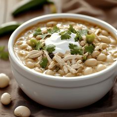 a white bowl filled with chicken and bean soup