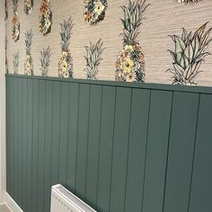 a bathroom with pineapple wallpaper and radiator