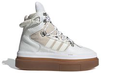 As part of an Alpine-themed collection with Beyonce's athleisure brand, the Ivy Park x adidas women's Super Sleek Boot 'Icy Park' is a striking sneaker-boot made for the mountains. The high-cut collar and premium leather and suede upper are immediately eye-catching, while the metal hardware and elastic bungee cord add to the mountaineering aesthetic. The towering silhouette is mounted on an exaggerated gum rubber sole unit, featuring a herringbone traction pattern for reliable grip even on the m Adidas Ivy Park Super Sleek Price, Beyoncé Ivy Park, Adidas Ivy Park, Adidas Sleek, Adidas Super, Athleisure Brands, Ivy Park, Hot Sneakers, Womens Athletic Shoes