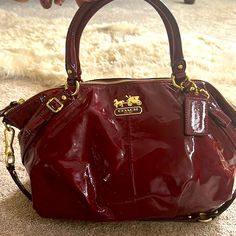 Coach Red Patent Leather Handbag. 2 Unnoticeable Stain Areas As Pictured. Gently Used. Burgundy Bag With Detachable Strap And Double Handle, Designer Burgundy Bag With Handles, Burgundy Travel Bags With Gold-tone Hardware, Burgundy Satchel With Double Handle, Designer Burgundy Bag With Detachable Strap, Burgundy Double Handle Satchel With Handle Drop, Red Handheld Bag For On-the-go, Designer Burgundy Satchel For Everyday Use, Designer Burgundy Satchel Bag