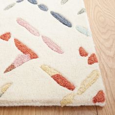 a white rug with colorful shapes on it