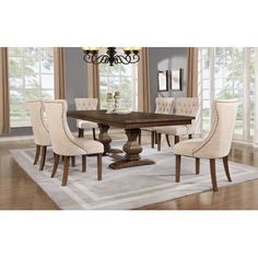 a dining room table with white chairs around it