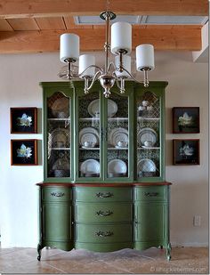 the china cabinet is painted in green