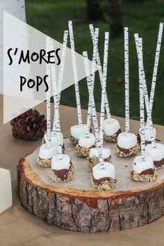 there are many small marshmallows on the table with white sticks sticking out of them