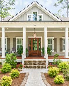 a white house with columns and steps leading to the front door