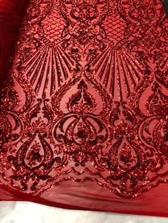 red sequinized fabric with intricate design