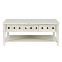 a white coffee table with four drawers