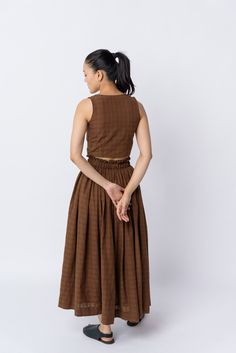 Introducing our gathered skirt, crafted from fine handwoven cotton. With its elasticated waist for ultimate comfort, this skirt features flattering gathers that accentuate the waistline. The flowy hem gracefully falls at the mid-calf line, adding a touch of elegance. Effortlessly style it with basic t-shirts or stroppy tops for a look that exudes both ease and enhancement. Style with Antique brown blouse Smocked elasticated waistline Voluminous flare 36" long (based on size S) 100% handwoven cot Strappy Tops, Brown Blouse, Basic T Shirts, Handwoven Fabric, Strappy Top, Gathered Skirt, Mens Accessories Fashion, Laid Back Style, Perfect Woman