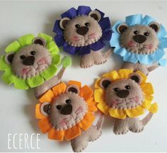 four felt lion brooches are arranged in a circle