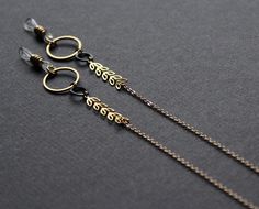 A modern glasses chain to match your trendy eyewear! :) * Brass leaves chain * Round brass links * Small round oxidized black brass link * Small gold plated chain * Clear rubber holders with brass beads - OR - Brass lobster clasps - OR - Both! Around 37in (94cm) from one end of the chain to the next. (Can be made shorter if you prefer! Simply contact me and we can arrange that quickly!) :) USEFUL TIPS: * Adjust the rubber holders by sliding the brass beads up to secure, and down to loosen. * If Ginkgo Aesthetic, Glasses Chain Aesthetic, Rose Gold Glasses, Chains Aesthetic, Glasses Lanyard, Trendy Eyewear, Glasses Chains, Glasses Strap, Sunglasses Strap