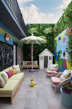 an outdoor patio with chairs, umbrellas and chalkboard on the wall behind it