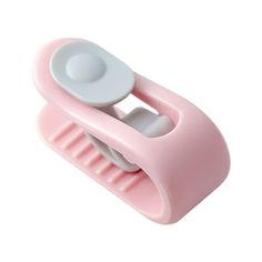 a pink and white toothbrush holder on a white background