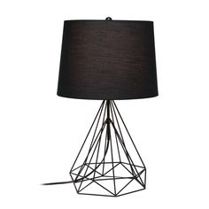 a table lamp with a black shade on the base and a white light behind it