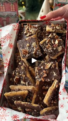 a box filled with chocolate and nuts on top of a table