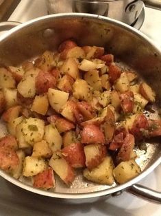 a pan filled with cooked potatoes on top of a stove