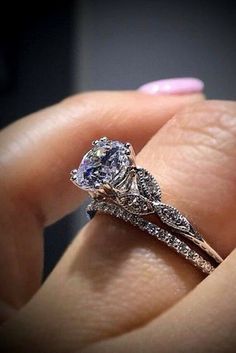 a woman's hand holding an engagement ring