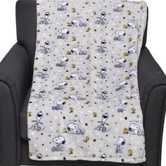 the snoopy dog blanket is on top of a chair