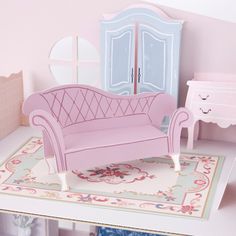 a doll house living room with pink furniture