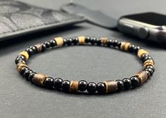 This wood bracelet is made with 4mm natural wood and black glass beads. An appropriate bracelet for men and for women. Makes a nice gift to friend, boyfriend, brother or Dad.  ✔️Bracelet size is the total length of the finished bracelet in inches. For a proper fit bracelet size should be slightly greater than wrist size. Sizing information is intended as a guideline, please order what feel most comfortable on you. These beads are taller than they are wide.  ✔️To measure your wrist, gently wrap a measuring tape or a strip of paper (or ribbon) around the narrow part of the wrist and measure that against a ruler. This will give you your wrist measurement. Add .75 (3/4) inch to 1" to the wrist measurement. This will give you a finished bracelet  **Your satisfaction is of the utmost importance Black Wooden Beads Bracelet For Gift, Black Wooden Beads Bracelet As Gift, Black Wooden Beaded Bracelets Gift, Black Wooden Beaded Bracelets, Gift Black Wooden Beaded Bracelets, Natural Wood And Black, Gift To Friend, Dad Bracelet, Chan Luu Bracelet