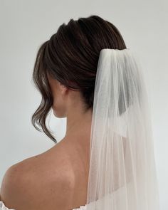 You already know how I feel about the knotted bun, but let’s also see it with a veil🤭 ⁣ SWIPE ⁣ When it comes to veil placement there are 3 different options for a low bun.⁣ ⁣ -Higher on the crown, which gives it more visibility from the front.⁣ -Above the bun, like this photo.⁣ -Underneath the bun, to really showcase the knot.⁣ ⁣ Above the bun is the most popular pick, but all are equally beautiful and I have bride’s that choose each option. It all comes down to your personal preference!⁣ ⁣ ... Bridal Ponytail Veil, Bride Hairstyles For Low Back Dress, Classic Bridal Updo With Veil, Wedding Day Low Bun, Wedding Hair Brunette With Veil, Low Bun Wedding Hair Veil, Wedding Hairstyles Bun With Veil, Bridal Hair French Twist With Veil, Wedding Updo Hairstyles With Veil