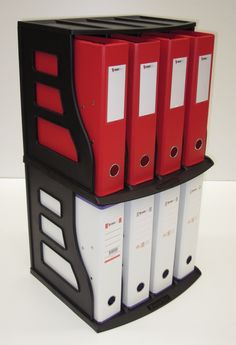 four red and white binders stacked on top of each other in a black holder