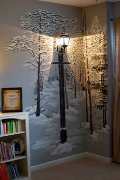 a room with a large mural on the wall and a book shelf in front of it