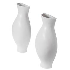 two white vases sitting next to each other