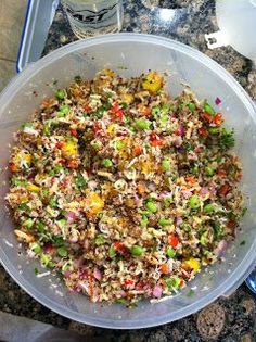 a bowl filled with rice and veggies on top of a granite countertop