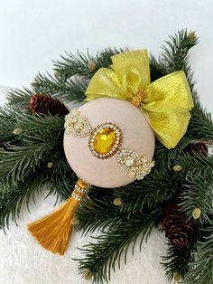 a christmas ornament with a yellow bow on it