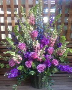 a vase filled with lots of purple flowers