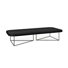 a black coffee table sitting on top of a metal frame base with an open end