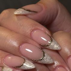 a woman's hand with some pink and white nails