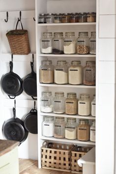 an organized pantry with pots, pans and other kitchen items on the shelves next to each other