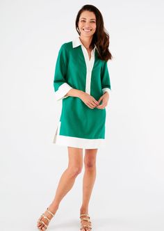 Want to feel easy, breezy, and chic this Summer? This high-style mini caftan in a popping kelly green is just the thing to help you channel your inner 60's movie star. The drapey, lightweight linen fabric will keep you cool while the covered buttons, color-blocked trim, and collar will deliver style that can take you beyond poolside hangouts. Sizing: Generous fit - We recommend that if you are between sizes to size downMake: Collared with covered buttons and contrast trim. In-seam pockets. Measurements: Length from shoulder to hem 34" size small (approximately)Fabric: Linen BlendCare: Hand wash or dry clean recommended The model is 5'9 and wears a size extra small. Spring Green Dresses With Split Neck, Green Split Neck Dresses For Spring, Split Neck Green Dresses For Spring, Chic Green Summer Tunic, Green Tunic For Spring Daywear, Green Tunic For Daywear, Spring Vacation Green Tunic, Skort Dress, Preppy Plaid