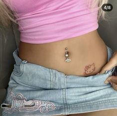 a woman with a hello kitty tattoo on her stomach