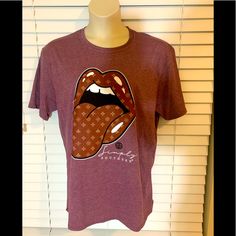 Nwot Never Been Worn It’s Color Is Burgundy With Black And White Mouth Shape With Tongue Out Very Soft And Different From Other Shirts.Measurements Are From The Top To The Bottom Is 291/2” And Ap To Ap Is 24”. Casual Brown T-shirt With Graphic Print, Casual Brown T-shirt With Screen Print, Casual Purple T-shirt For Fall, Casual Tan T-shirt With Graphic Print, Casual Tan T-shirt For Fall, Simply Southern, Colorful Shirts, Womens Tops, Tops & Tees