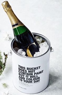 a bottle of champagne in a bucket with ice