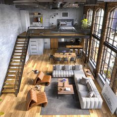 an aerial view of a living room, kitchen and dining area with stairs leading up to the second floor