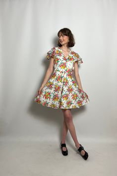 "1950s-early 60s Betty Barclay dress in a cross over style with ruffled sleeves! Gorgeous floral print! Excellent vintage condition!  *clothes have been fitted to model please check measurements*  Measurements -  Bust - 37\" Waist - 30\" Length - 35.5\"" Vintage V-neck Dress With Ruffles, Retro V-neck Dress With Ruffles, Vintage V-neck Floral Dress For Spring, Retro V-neck Dress For Garden Party, Fitted 1950s V-neck Dress, Vintage V-neck Dress For Garden Party, Vintage V-neck Fit And Flare Dress, Vintage Fit And Flare V-neck Dress, 1950s Style Ruffled Dresses