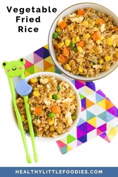 two bowls filled with rice and vegetables on top of a colorful place mat next to chopsticks