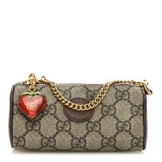 This is an authentic GUCCI GG Supreme Monogram Strawberry Retro Interlocking G Barrel Coin Purse in Beige, Ebony, and New Acero. This stylish mini bag is crafted of Gucci GG supreme monogram coated canvas, with a brown leather trim. It features a polished gold chain strap with a clasp at the end and a strawberry zipper that opens to a compact beige microfiber interior. Leather Trim, Chain Strap, Leather Trims, Gold Chain, Mini Bag, Gold Chains, Coin Purse, Brown Leather, Barrel