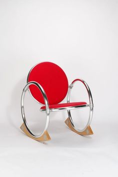 a red and chrome rocking chair against a white background with no one in the photo