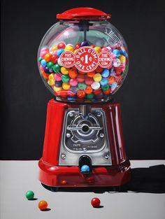 an old fashioned gumball machine with lots of candy