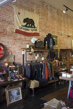 the inside of a clothing store with an american flag hanging from the wall and other items on display