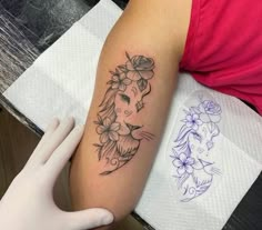 a woman's arm with a tattoo on it that has a lion and flowers on it