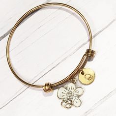 "Gold and White Flower Bracelet, Initial Bangle, Gold Flower Jewelry, Gold Hawaiian Bangle, Tropical Flower Gifts for Her, Flower Girl Bangle This gold stainless steel expandable bangle features an adorable gold and white enamel flower charm with rhinestone accents. It comes with a personalized initial; optional Swarovski Crystal birthstone is also available. INCLUDES ♥Gold stainless steel expandable bangle bracelet is non-tarnish, lead and nickel free. ♥Bangle measures 2.5\" (65mm) across and f Flower-shaped Bracelets With Charms For Gift, Adjustable White Charm Bracelet With Flower Charm, White Adjustable Charm Bracelet With Flower Charm, Adjustable Gold Jewelry With Flower Decoration, Flower Charm Bracelet As A Gift, Adjustable Flower-shaped Bracelets With Charms, Adjustable Flower-shaped Charm Bracelets, Adjustable Flower Charms Bracelets, Personalized Gold Flower Bracelets