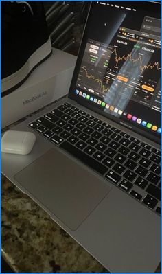 an open laptop computer sitting on top of a desk next to a mouse and keyboard