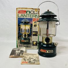 an old lantern is sitting next to a magazine