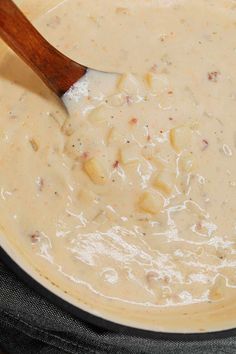 a wooden spoon in a pot filled with soup