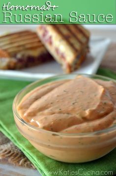 a bowl of hummust russian sauce next to grilled cheese sandwiches